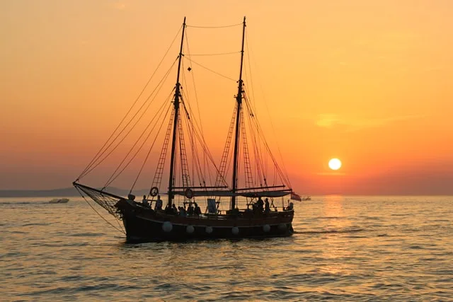 A ship sailing in sunset